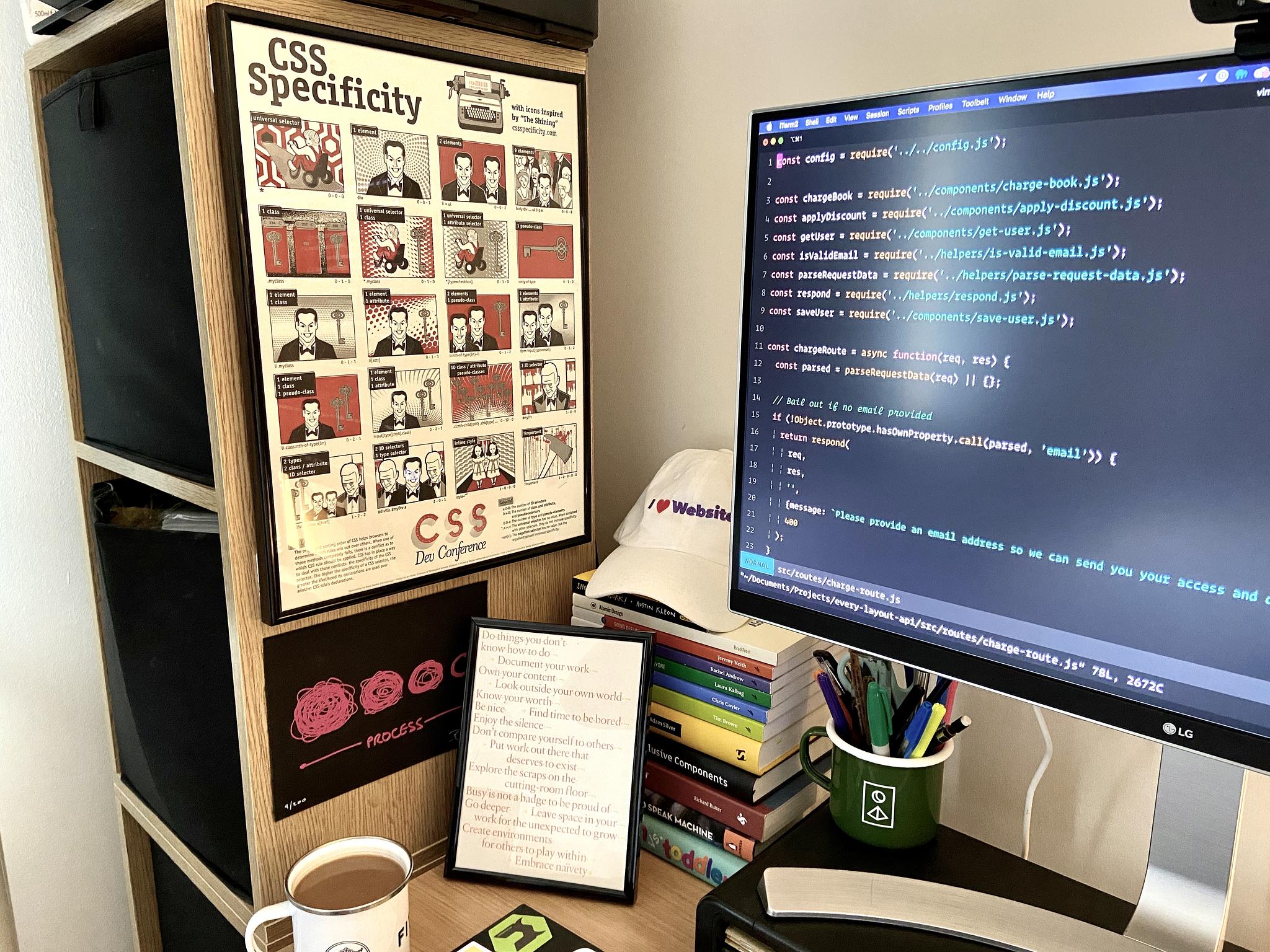 The Shining CSS Specificity poster framed on a wall by a monitor